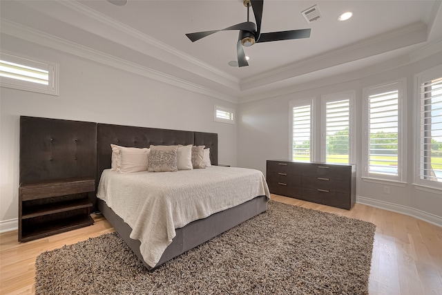 bedroom featuring ceiling fan, multiple windows, and light hardwood / wood-style floors