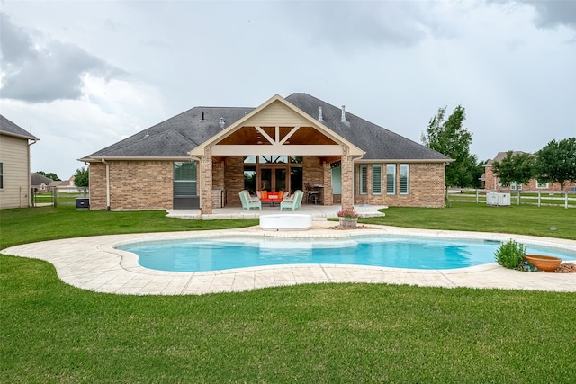 rear view of house with a yard and a patio