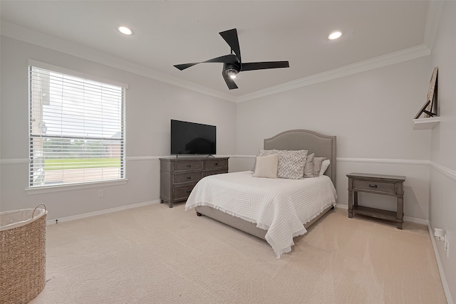 carpeted bedroom with ceiling fan and ornamental molding