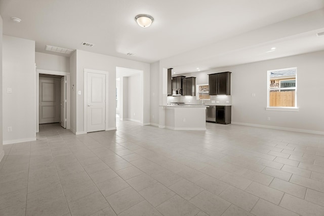 unfurnished living room featuring light tile patterned floors