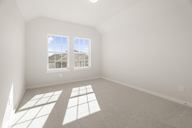 bonus room featuring light colored carpet and vaulted ceiling