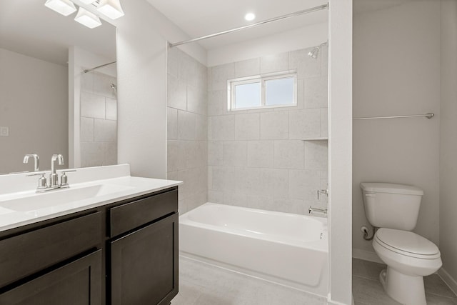 full bathroom featuring tile patterned flooring, toilet, vanity, and tiled shower / bath