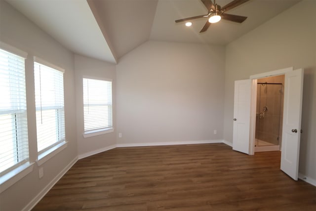 unfurnished room with ceiling fan, a wealth of natural light, dark hardwood / wood-style flooring, and vaulted ceiling