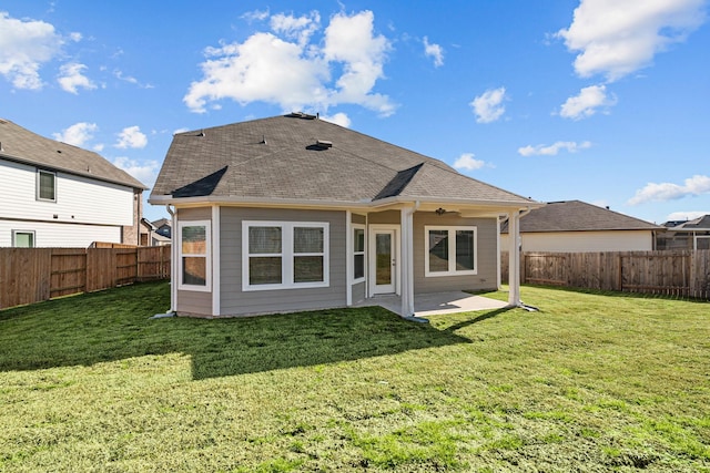 rear view of house with a patio and a lawn