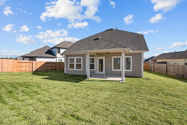 back of house with a patio and a lawn