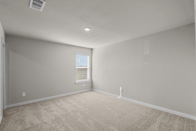 unfurnished room featuring light colored carpet