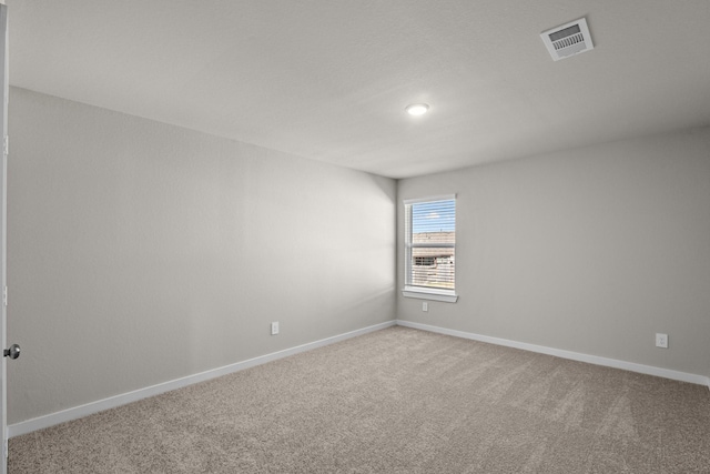 empty room featuring light carpet