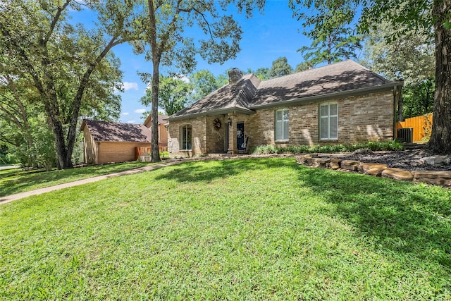 112 Broken Bough Ln, Conroe, TX 77304 - view of front of home featuring brick siding, a chimney, a front lawn, and fence