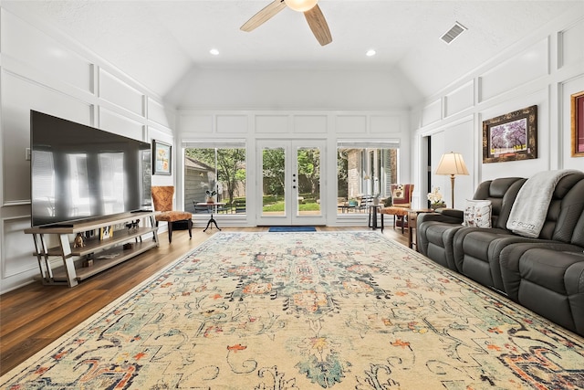 living room with ceiling fan, dark hardwood / wood-style flooring, high vaulted ceiling, and french doors