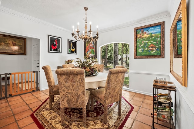 dining room featuring a notable chandelier, light tile patterned flooring, and ornamental molding