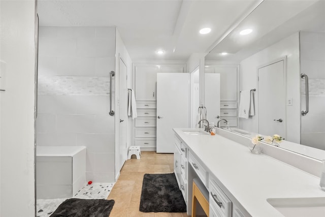 bathroom featuring a shower, vanity, and tile patterned flooring