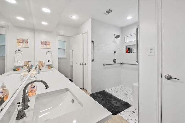 bathroom with vanity and tiled shower