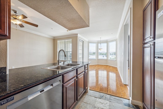 kitchen with crown molding, dishwasher, ceiling fan, sink, and dark stone countertops