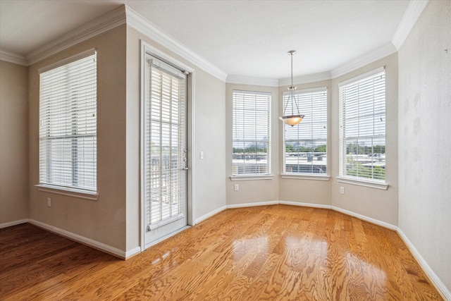 unfurnished dining area featuring a wealth of natural light and ornamental molding