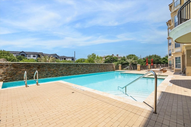 view of swimming pool with a patio area