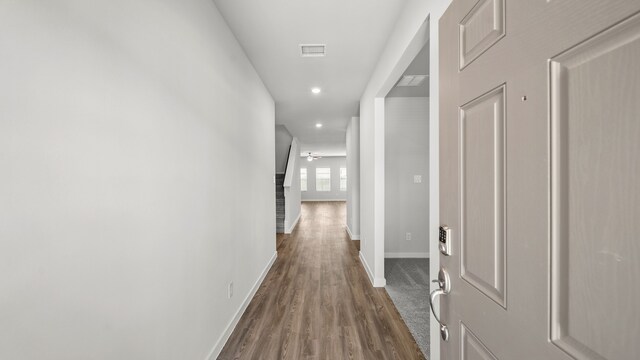 hall with hardwood / wood-style flooring