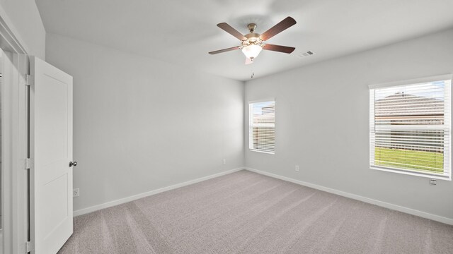 unfurnished room featuring ceiling fan and light colored carpet