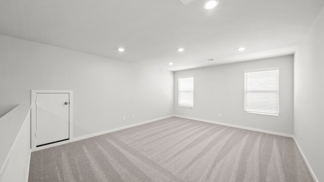 spare room with light colored carpet