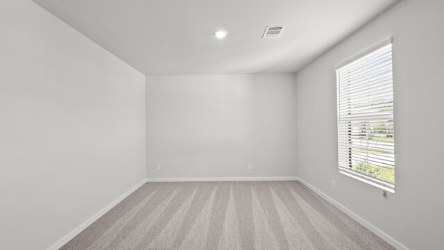 unfurnished room with light carpet