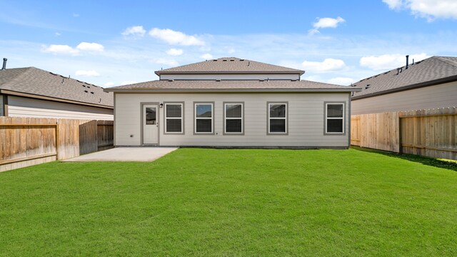 rear view of property with a patio area and a lawn