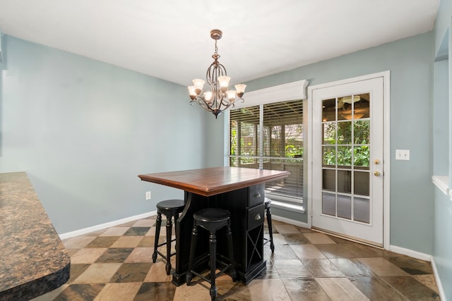 tiled dining space featuring an inviting chandelier