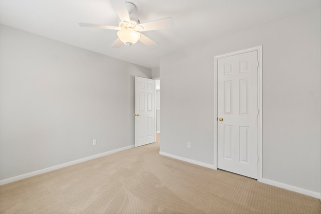 unfurnished bedroom featuring ceiling fan and light colored carpet