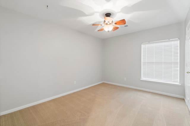 spare room with light carpet and ceiling fan