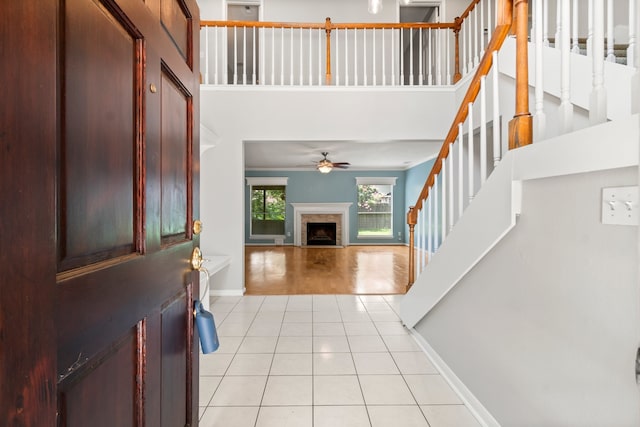 tiled entrance foyer featuring a high ceiling and ceiling fan