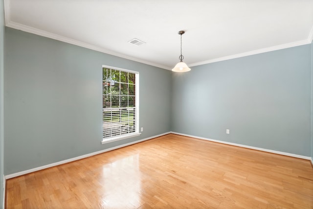 unfurnished room with crown molding and light wood-type flooring