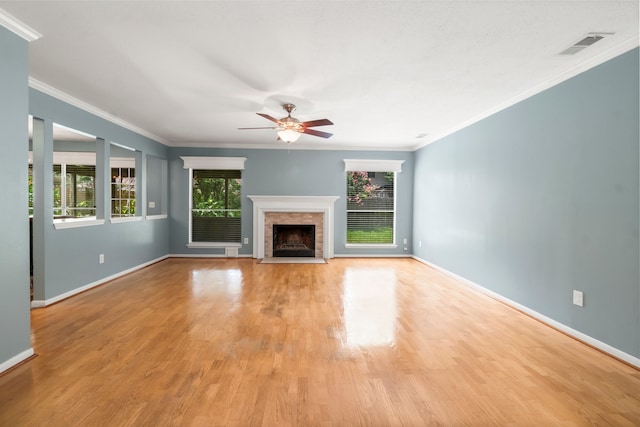 unfurnished living room featuring ornamental molding, ceiling fan, and light wood-type flooring