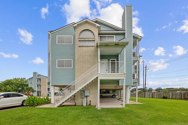 rear view of property with a yard and a patio