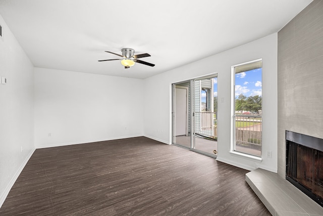 unfurnished living room with ceiling fan and dark hardwood / wood-style flooring