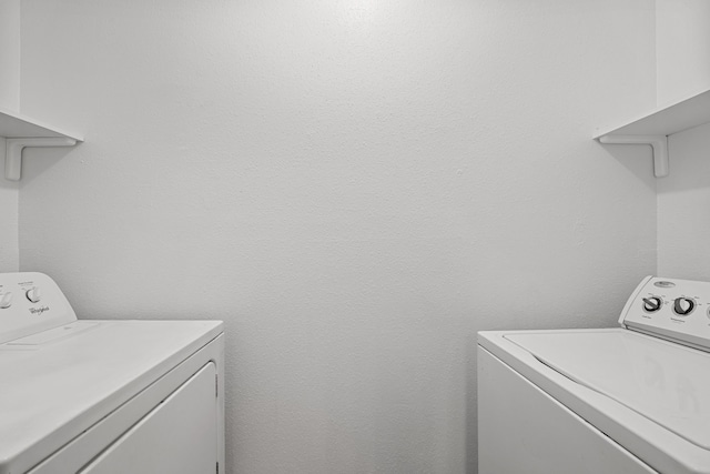 clothes washing area featuring washer and dryer