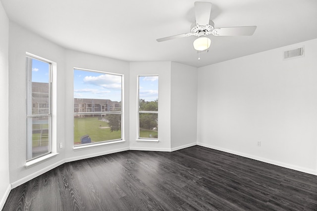 empty room with dark hardwood / wood-style flooring and ceiling fan