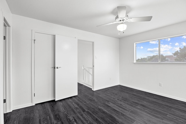 unfurnished bedroom featuring ceiling fan and dark wood-type flooring