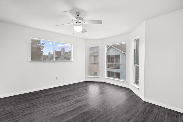 empty room with ceiling fan and dark hardwood / wood-style flooring