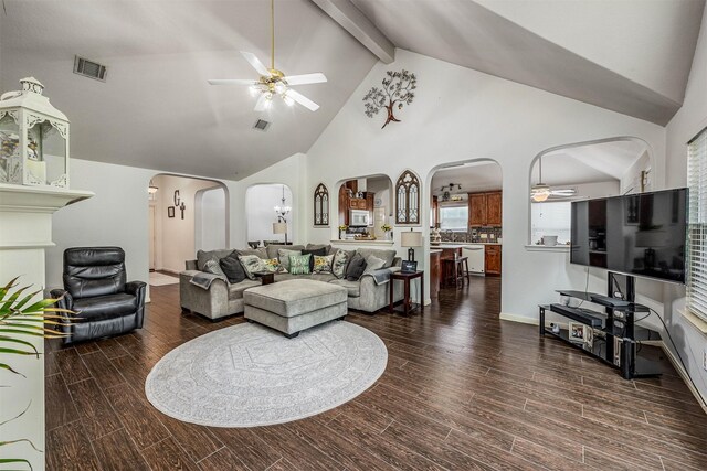 living room with ceiling fan, high vaulted ceiling, beamed ceiling, and dark wood-type flooring