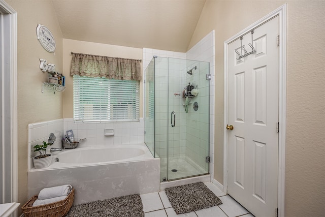 bathroom with tile patterned flooring, independent shower and bath, and vaulted ceiling