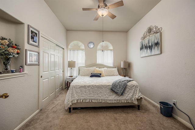 bedroom featuring ceiling fan, a closet, and light carpet