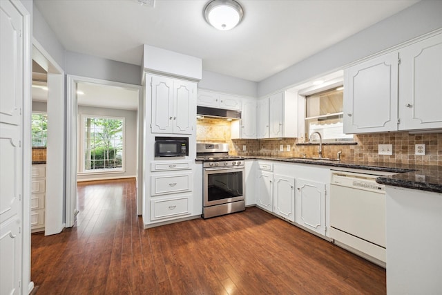 kitchen featuring white cabinetry, decorative backsplash, gas range, white dishwasher, and sink