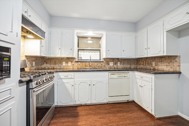 kitchen with white cabinetry, stainless steel gas range oven, dark stone countertops, white dishwasher, and sink