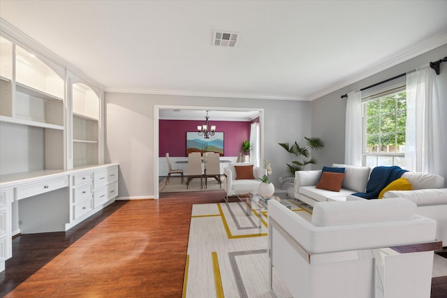 living room featuring dark hardwood / wood-style floors, ornamental molding, and a notable chandelier