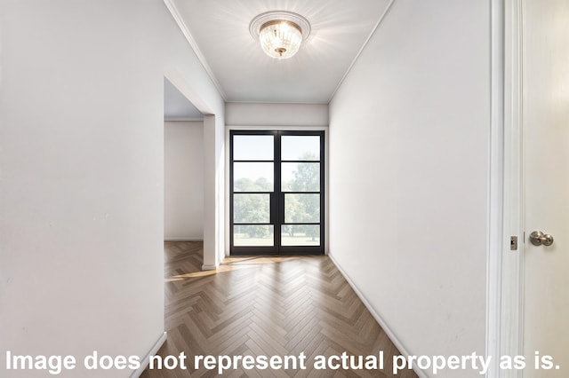 interior space with ornamental molding, parquet floors, and french doors