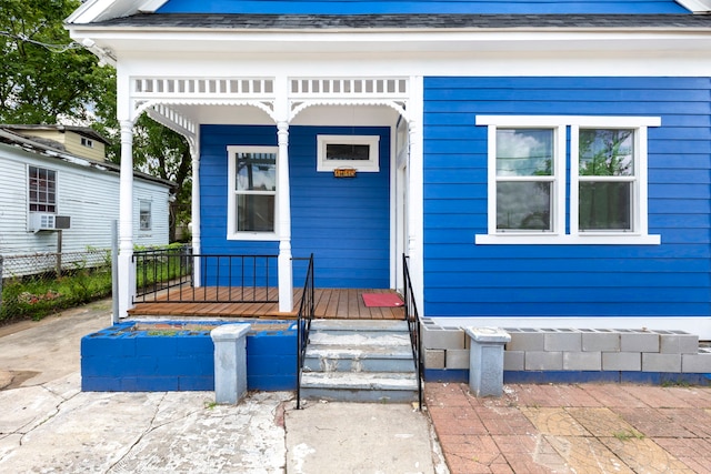 view of front of house with a porch and cooling unit