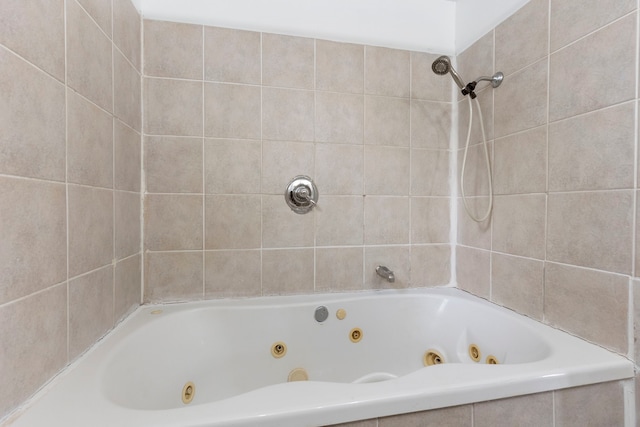 bathroom with a relaxing tiled tub