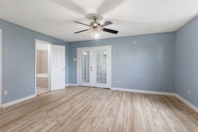 empty room with ceiling fan, french doors, a textured ceiling, and light wood-type flooring