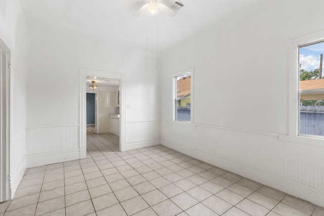 tiled empty room with ceiling fan