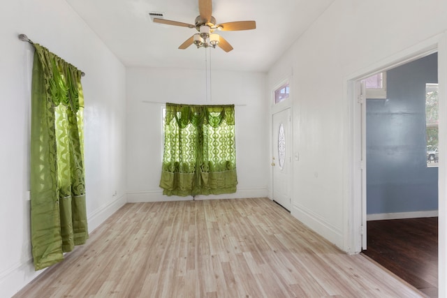 empty room with ceiling fan and light wood-type flooring