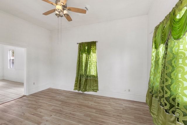 empty room featuring ceiling fan and light hardwood / wood-style flooring