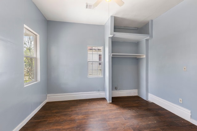 unfurnished bedroom featuring ceiling fan, a closet, and dark hardwood / wood-style floors